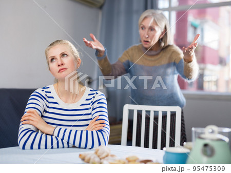 Mature woman scolds her adult daughter Mature woman scolds her adult daughter 95475309