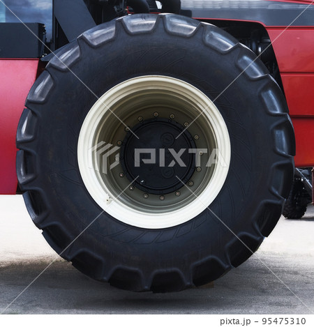 Black tractor wheel, close up. Agronomy, farming, husbandry concept. Black tractor wheel, close up. Agronomy, farming, husbandry concept. 95475310