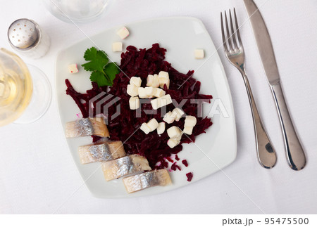 Pieces of chopped herring with beet and cheese served on plate Pieces of chopped herring with beet and cheese served on plate 95475500