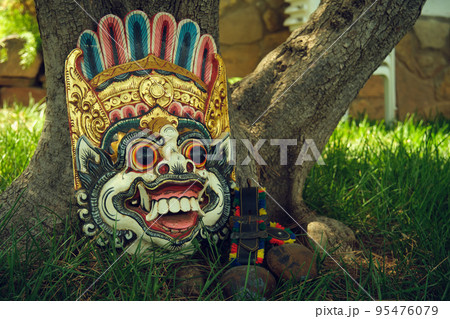 ritual Indonesian mask near a tree 95476079
