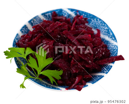Salad of grated baked beetroot on plate with fresh parsley Salad of grated baked beetroot on plate with fresh parsley 95476302