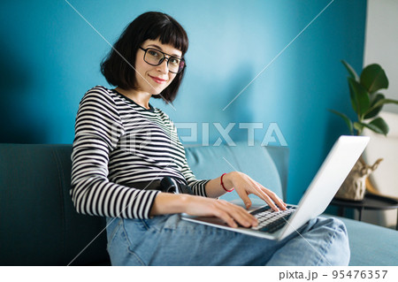 Attractive woman using laptop for communication, video chatting. Online meeting in video call. 95476357