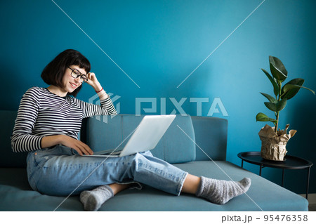 Attractive woman using laptop for communication, video chatting. Online meeting in video call. 95476358