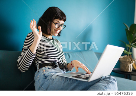Attractive woman using laptop for communication, video chatting. Online meeting in video call. 95476359