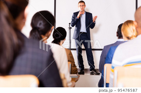Confident lecturer speaking to businesspeople at seminar Confident lecturer speaking to businesspeople at seminar 95476587
