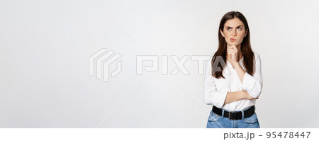 Portrait of female entrepreneur thinking, making choice, standing thoughtful, white studio background Portrait of female entrepreneur thinking, making choice, standing thoughtful, white studio background 95478447