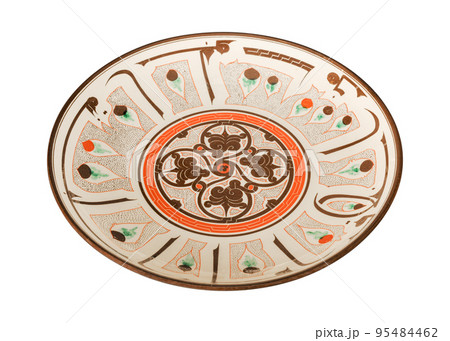 A vintage oriental ceramic plate isolated on a white background 95484462