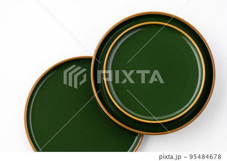A set of green ceramic plates on a white background. Top view 95484678