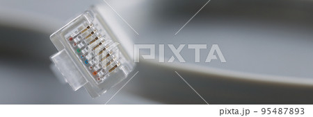 Internet connector on grey background, focus on cable with plastic clip Internet connector on grey background, focus on cable with plastic clip 95487893