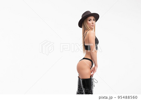 Alluring young woman in black underwear and boots Alluring young woman in black underwear and boots 95488560