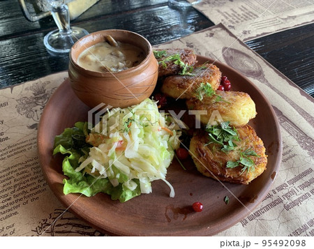 Potato pancakes with sauce, sauerkraut. Studio Photo Potato pancakes with sauce, sauerkraut. Studio Photo 95492098