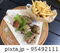 Street fast food, French fries, pita bread and pieces of grilled meat. Studio Photo 95492111