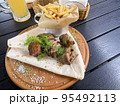 Street fast food, French fries, pita bread and pieces of grilled meat. Studio Photo 95492113