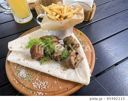 Street fast food, French fries, pita bread and pieces of grilled meat. Studio Photo Street fast food, French fries, pita bread and pieces of grilled meat. Studio Photo 95492113