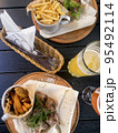 Street fast food, French fries, pita bread and pieces of grilled meat. Studio Photo 95492114