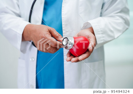 Asian woman doctor holding red heart for health in hospital. Asian woman doctor holding red heart for health in hospital. 95494324