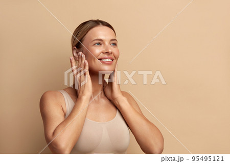 Smiling Woman Touching Chics. Portrait of Attractive Woman Touching her Skin 95495121