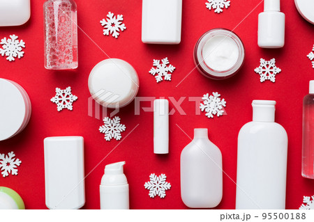 Makeup products and Christmas decorations on color background. Top view New year Beauty concept 95500188
