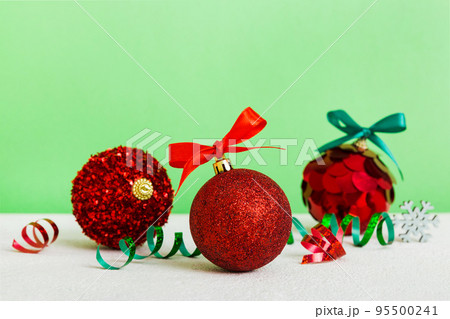 Christmas ball on colored background. decoration bauble with ribbon bow with copy space 95500241