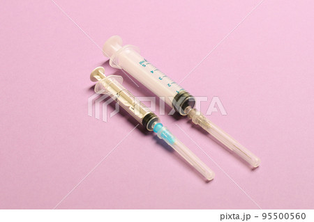 Top view of medical syringes on colorful background with copy space. Injection equipment concept 95500560