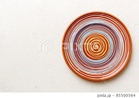 Top view of empty colorful plate on cement background. Empty space for your design 95500564