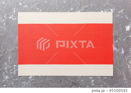 Top view of red tablecloth for food on cement background. Empty space for your design 95500585