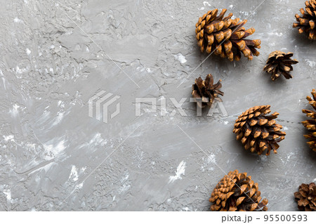 Christmas pine cones on colored paper border composition. Christmas, New Year, winter concept. Flat lay, top view, copy space Christmas pine cones on colored paper border composition. Christmas, New Year, winter concept. Flat lay, top view, copy space 95500593