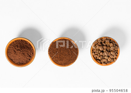 Three cups of coffee beans, ground coffee and cocoa for comparison. Three cups of coffee beans, ground coffee and cocoa for comparison. 95504658