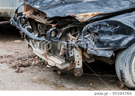 Broken car after accident on road. Auto without bumper and headlights. Insurance concept. 95504760