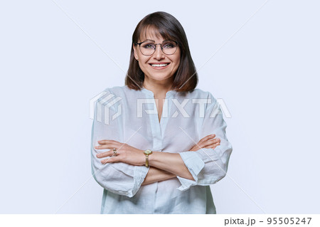 Attractive middle aged woman looking at camera on white background Attractive middle aged woman looking at camera on white background 95505247