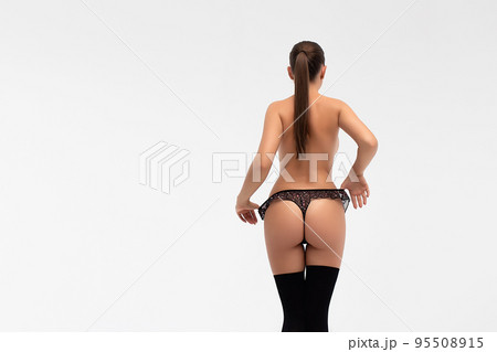 Crop female in underwear touching buttocks 95508915