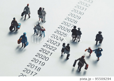 西暦の横を歩くミニチュアの人々 95509294