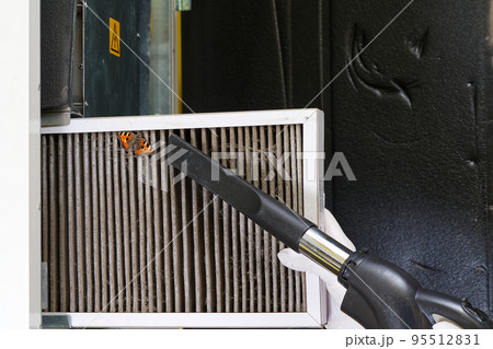 Replacing filter in the central ventilation system. hvac filter replacing home central air system 95512831