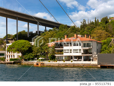 Traditional waterfront house, under Bosphorus bridge, and green hill with dense trees, Istanbul, Turkey Traditional waterfront house, under Bosphorus bridge, and green hill with dense trees, Istanbul, Turkey 95513791