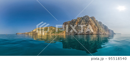 Yachts in the Sea on a background of rocky shores. Sea landscape with yachts and rocky coastline. Copy space. The concept of an summer holydays, relax, active and healthy life in harmony with nature. Yachts in the Sea on a background of rocky shores. Sea landscape with yachts and rocky coastline. Copy space. The concept of an summer holydays, relax, active and healthy life in harmony with nature. 95518540