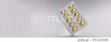 Blister with yellow jelly tablets, daily dose of medication for person Blister with yellow jelly tablets, daily dose of medication for person 95520580