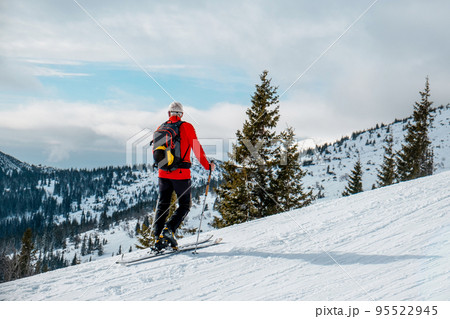 senior man ski tour walking up looking on landscape 95522945