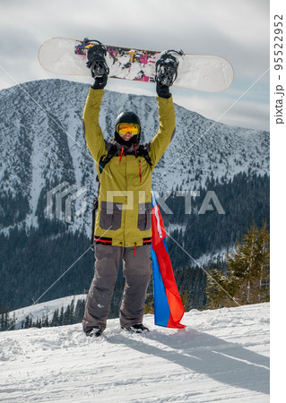 man snowboarder with slovakia flag at ski resort slope man snowboarder with slovakia flag at ski resort slope 95522952