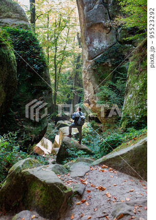 man hiker with backpack in canyon with forest man hiker with backpack in canyon with forest 95523292