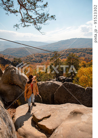 woman traveler enjoying autumn view woman traveler enjoying autumn view 95523302