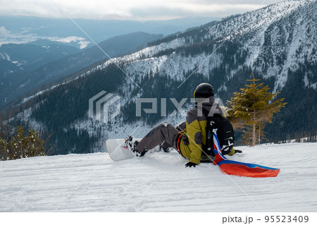 man snowboarder with slovakia flag at ski resort slope man snowboarder with slovakia flag at ski resort slope 95523409