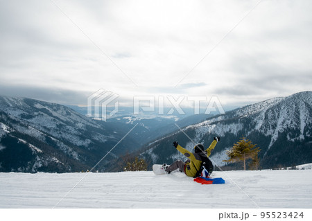 man snowboarder with slovakia flag at ski resort slope man snowboarder with slovakia flag at ski resort slope 95523424