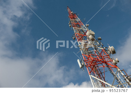 Large transmission tower against deep blue sky and clouds 95523767