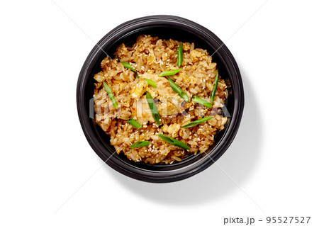Spicy chahan fried rice dish with chicken, sesame and green onion in black bowl Spicy chahan fried rice dish with chicken, sesame and green onion in black bowl 95527527