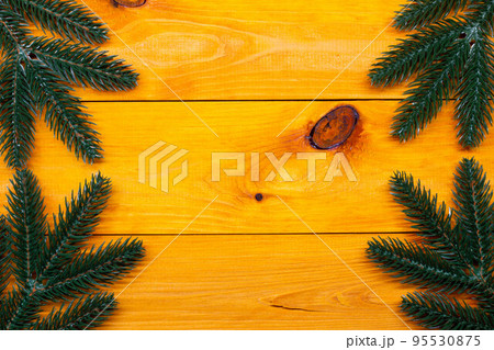 Christmas background. Fir on the wooden table. New Year background. Christmas images and backgrounds. Xmas pine fir lush tree. Bright Winter holiday composition. Greeting card, banner and poster. 95530875