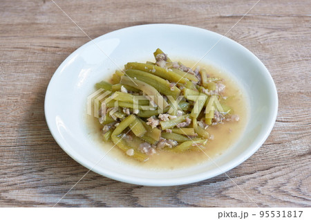 fried slice lotus stems with chop pork in soy sauce on plate 95531817
