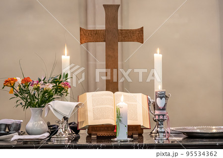 Festive interior decoration with burning candles in temple Church Christianity The ceremony of infant baptism Baptismal 95534362