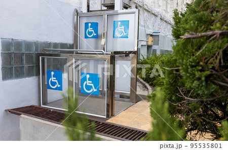 Accessible Elevator with sign. Disabled persons lift near modern apartment facility. Accessible Elevator with sign. Disabled persons lift near modern apartment facility. 95535801