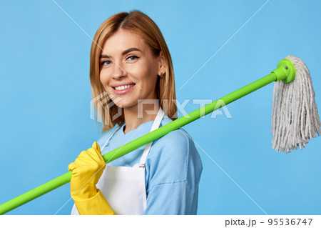 woman in rubber gloves holding mop and bucket 95536747