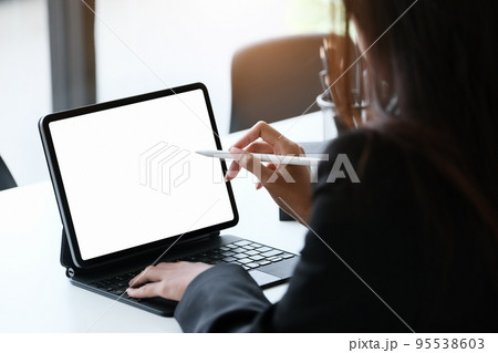 Business Women use a tablet for work, a blank tablet screen can add text or other media Business Women use a tablet for work, a blank tablet screen can add text or other media 95538603